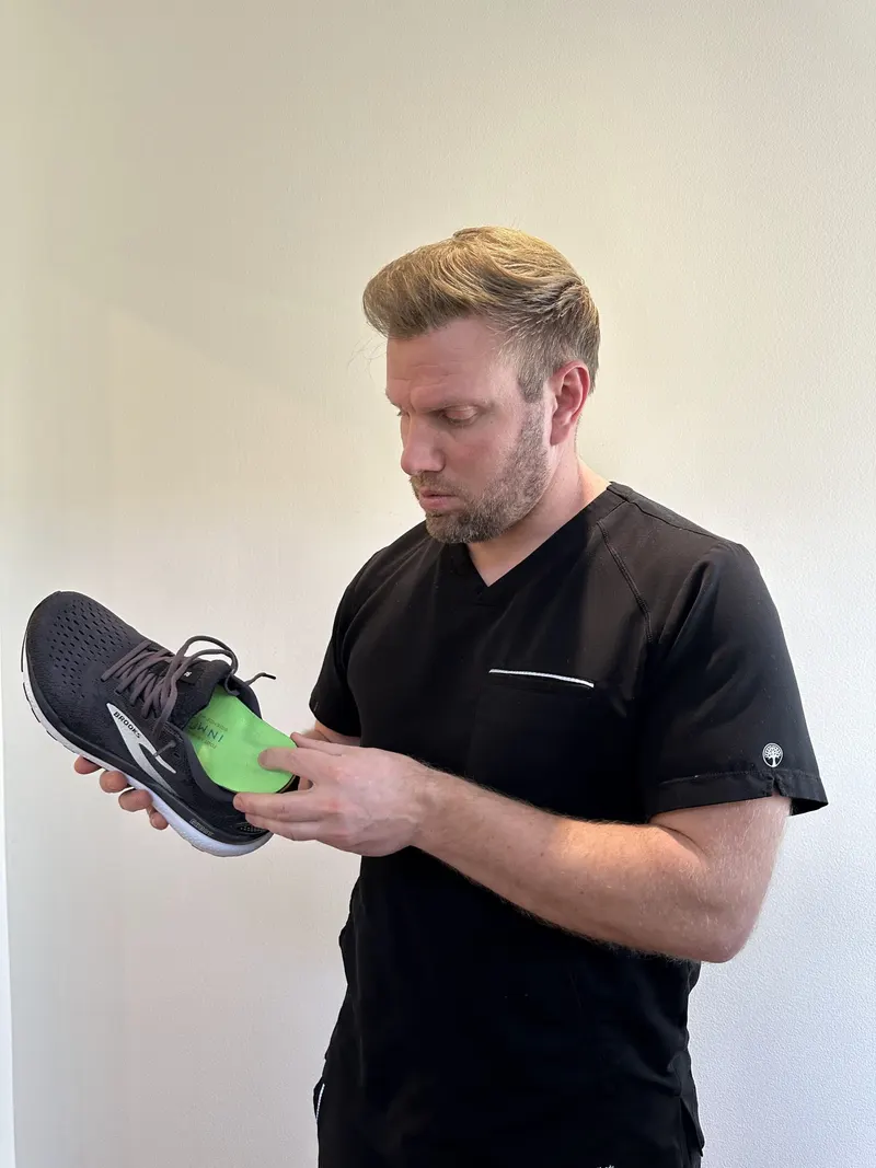A custom orthotic being fitted into a shoe